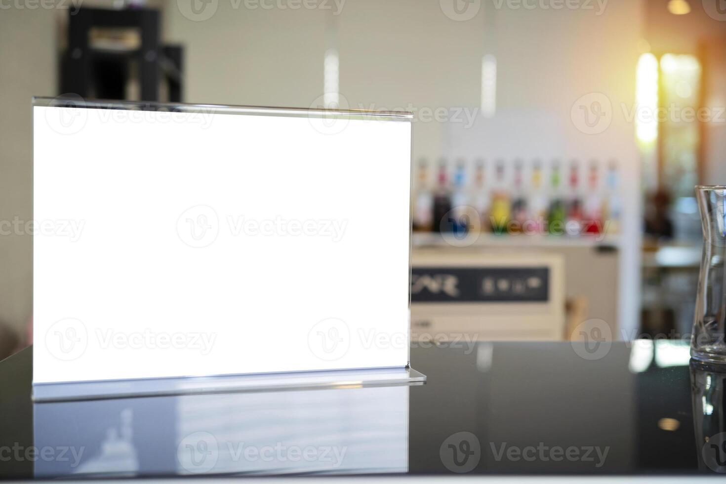 Stand mock up menu frame standing on wood table in bar restaurant cafe. space for text. photo