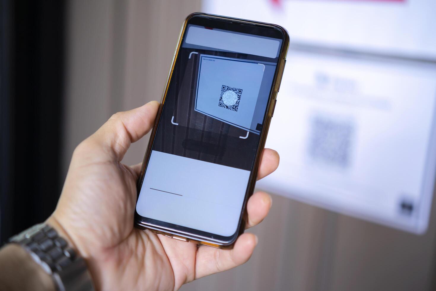 Man's hand holding smartphone scanning QR code on white background, business concept photo