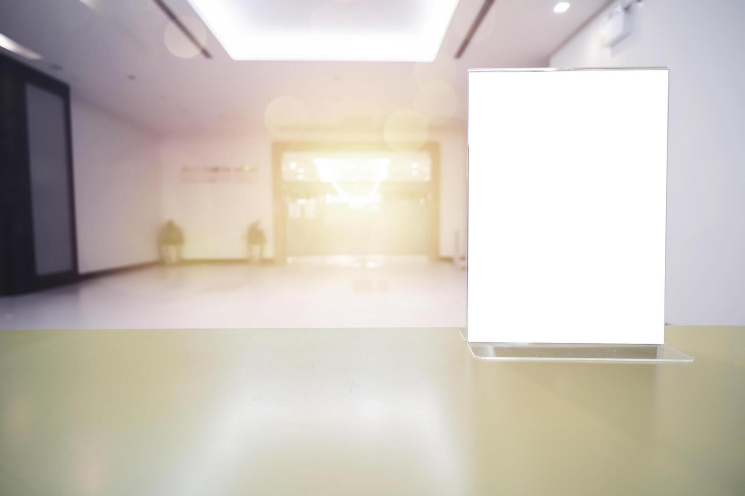 Blank flyer mockup glass plastic transparent holder poster display in hotel lobby photo