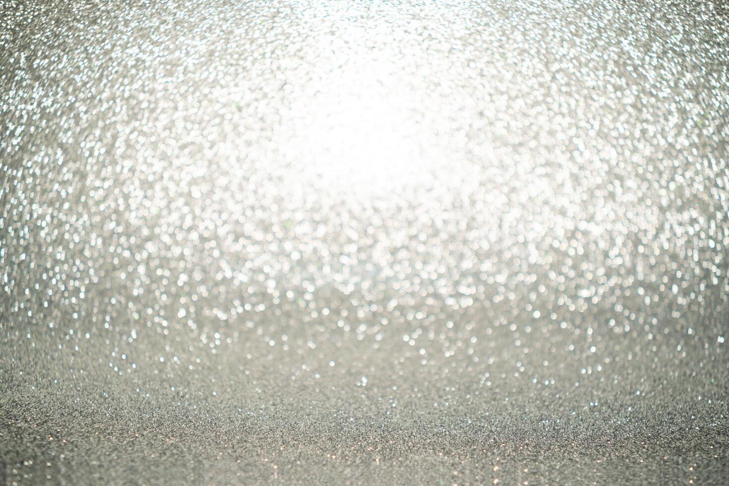 Silver Sparkling Lights Festive background with texture. Abstract Christmas twinkled bright bokeh defocused and Falling stars. Winter Card or invitation photo