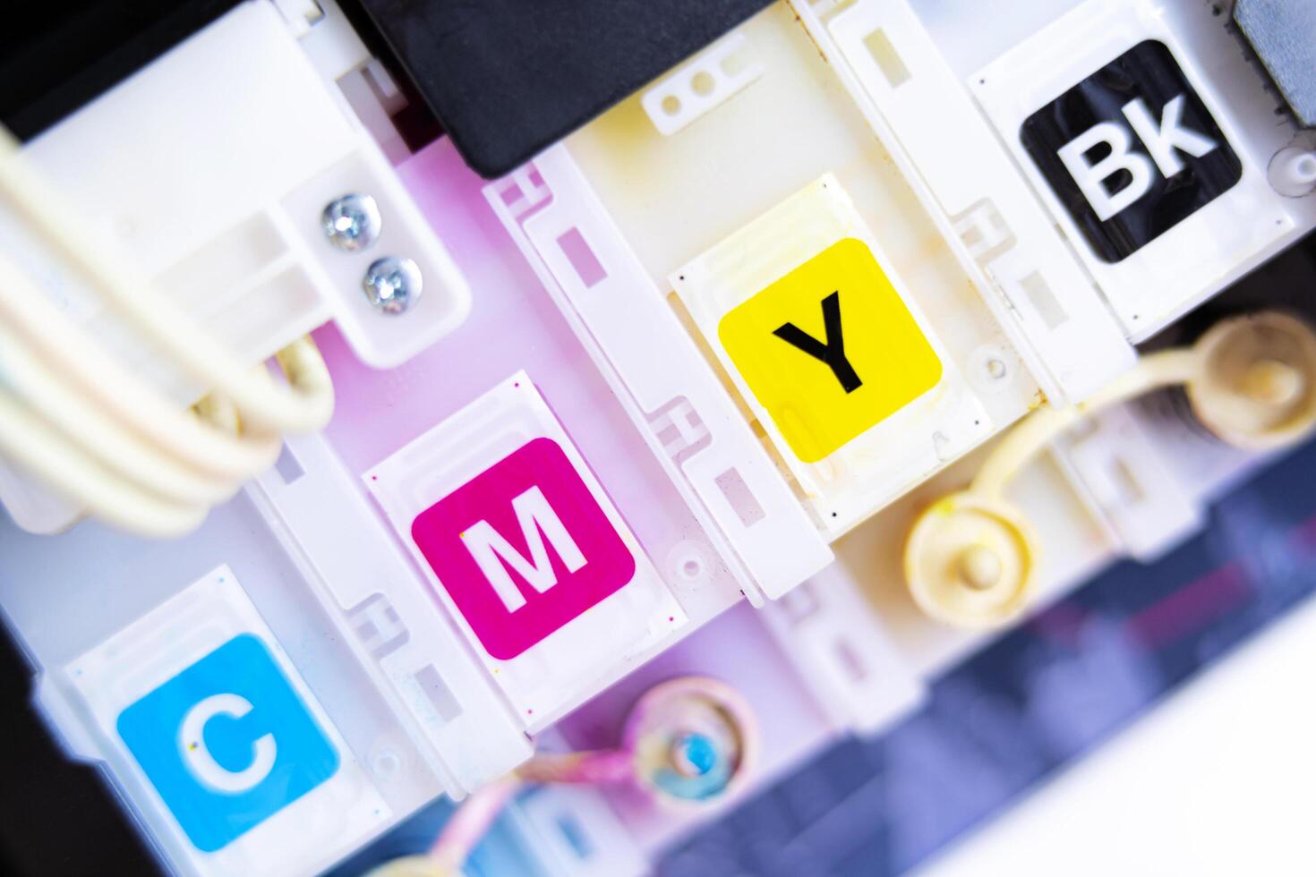 Printer in cartridges.select focus. ink tank for refill, CMYK ink tank installed on the side of inkjet printer photo