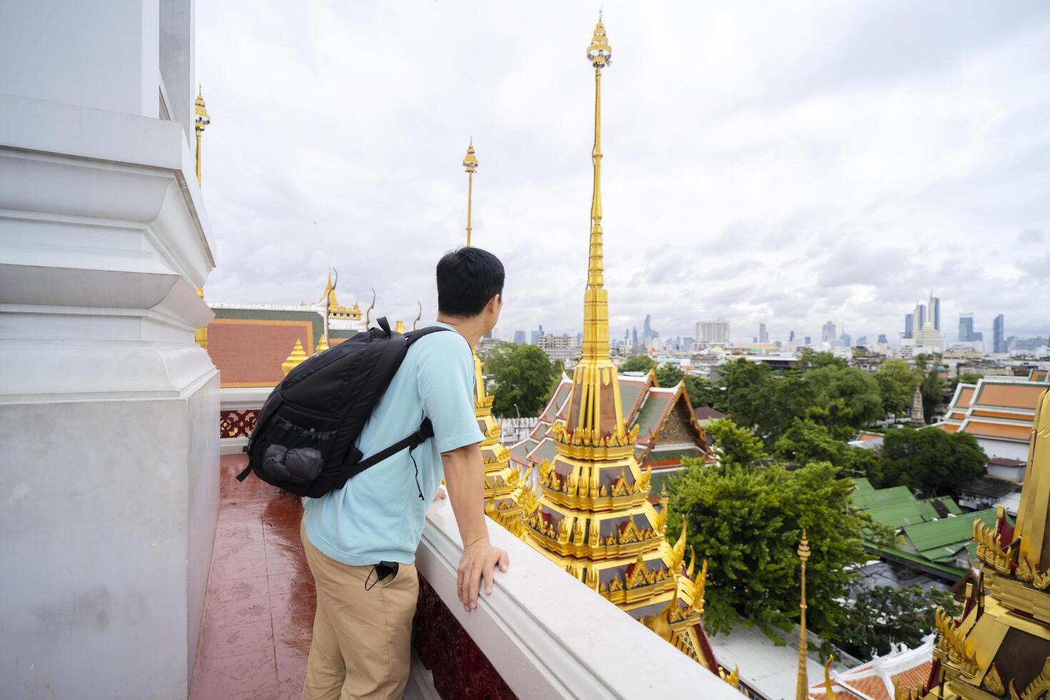Young Asian backpackers have enjoyed visiting Thai temples during their summer vacation in Bangkok. photo
