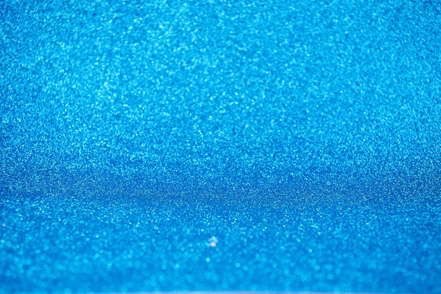 Blue beautiful abstract background of holiday lights, glitter photo