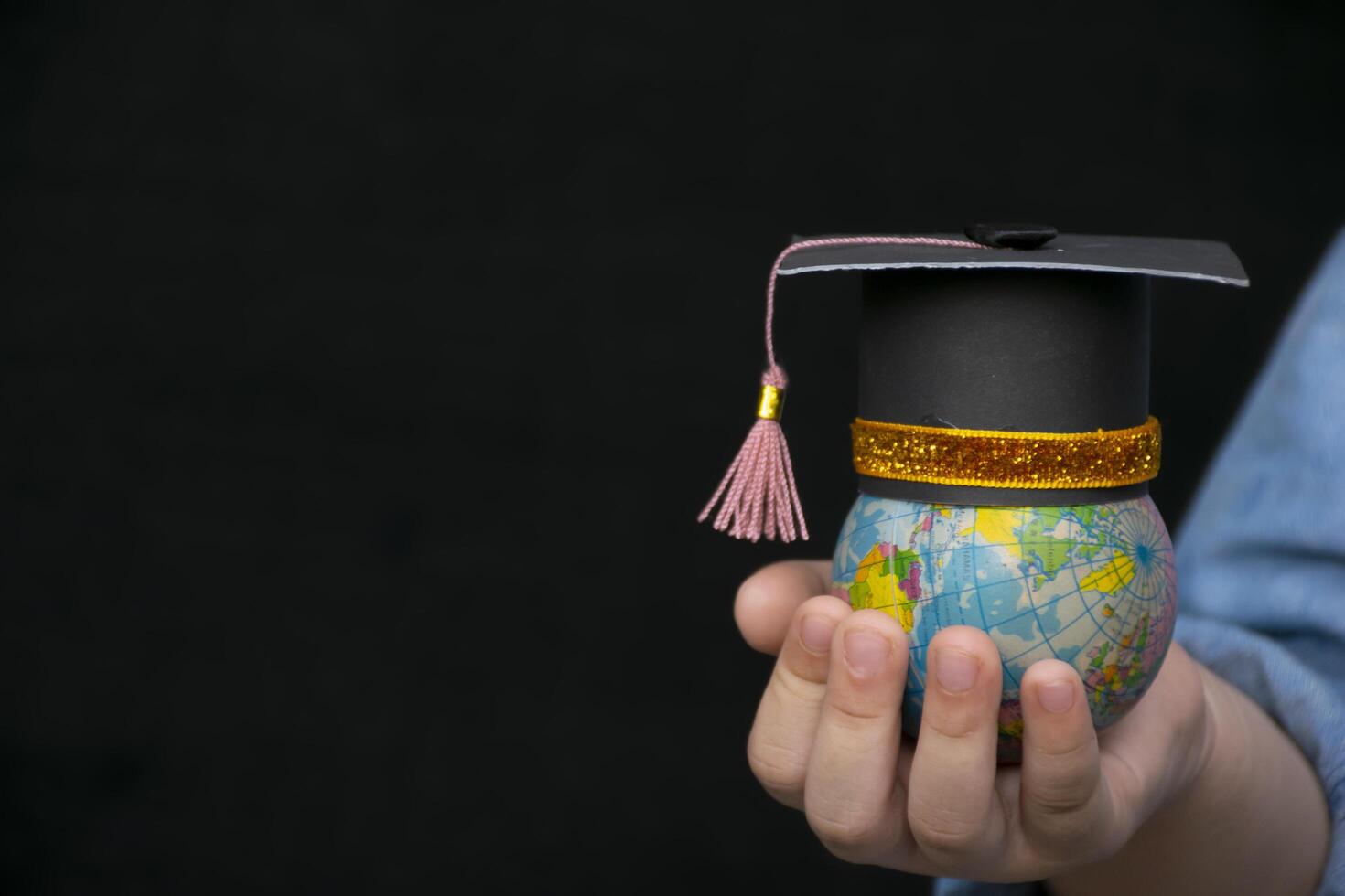 Education in Global world, Graduation cap on the girl's hand holding Earth globe model map with Radar background in hands. Concept of global business study, abroad educational, Back to School photo