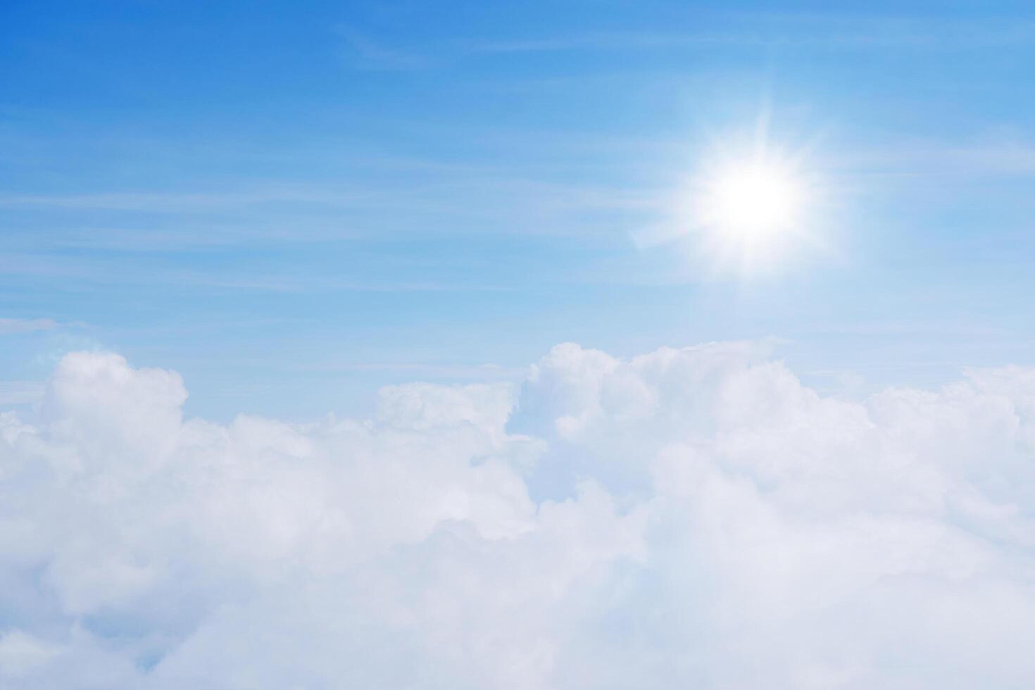 The sky is full of clouds floating around, both small and large, the sun is shining brightly. The atmosphere is on the plane. photo