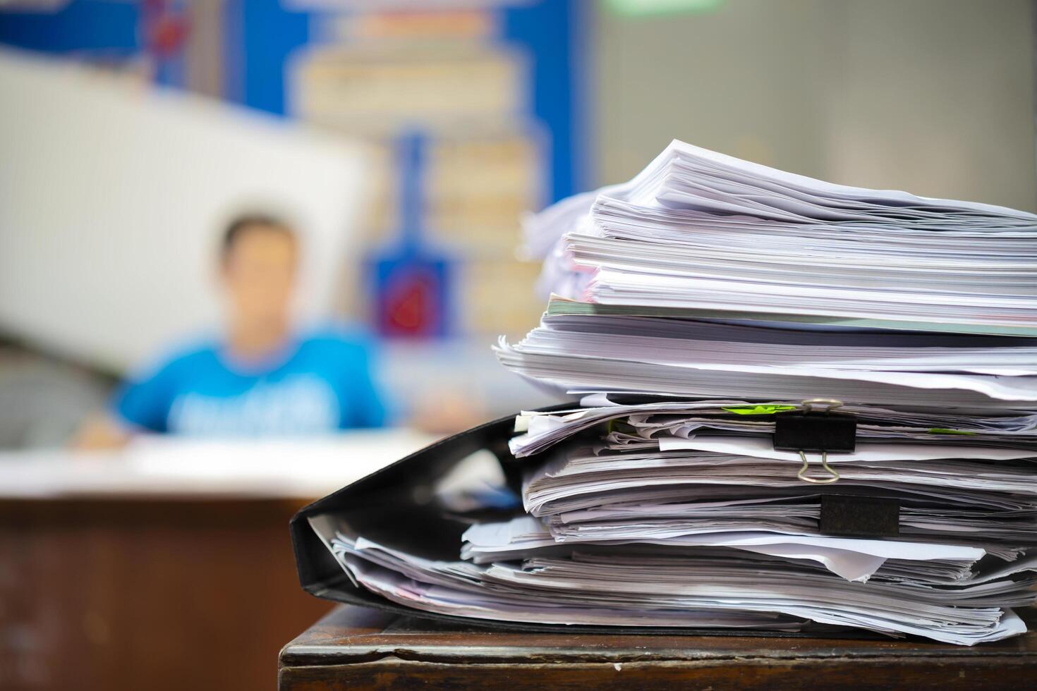 Business people sitting and working, Paper stack on the desk related to business functions. photo