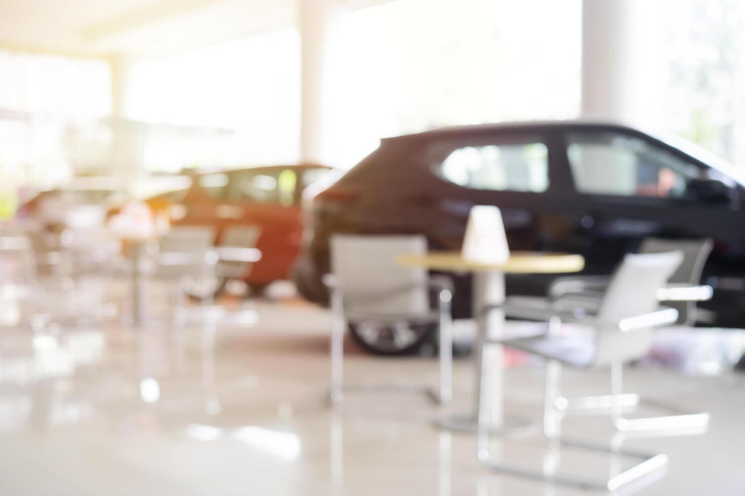 Blurred background of new cars displayed in luxury showroom with light bokeh in motor show event photo