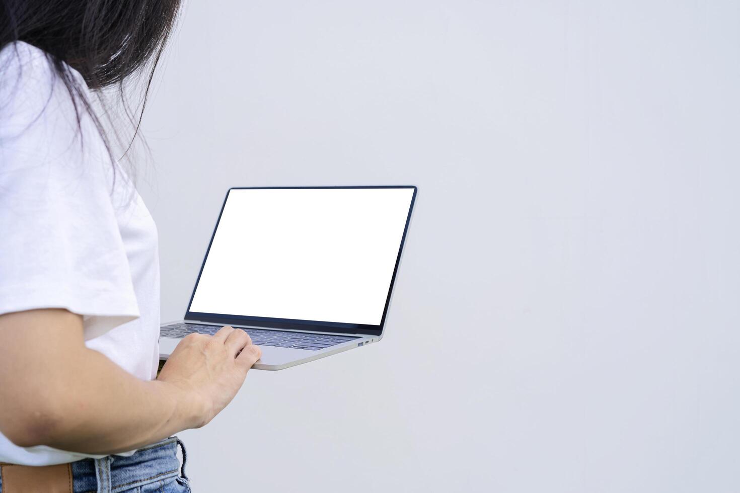Asian businesswoman working on laptop computer isolated over white background. photo