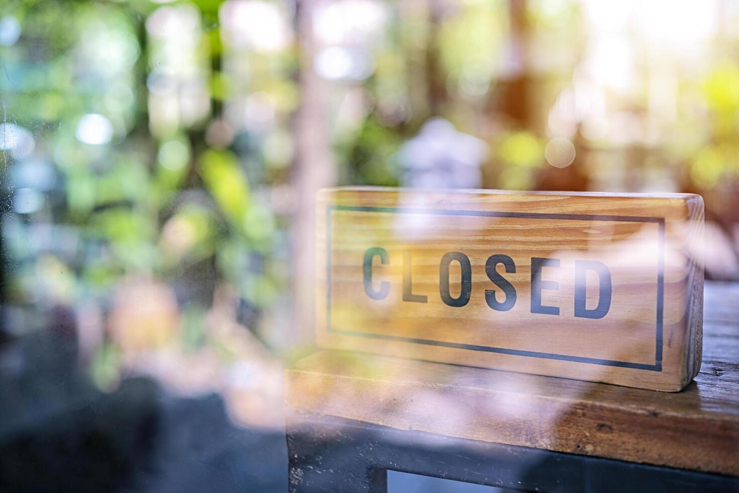 Vintage looking Closed sign in a shop showroom with reflections photo