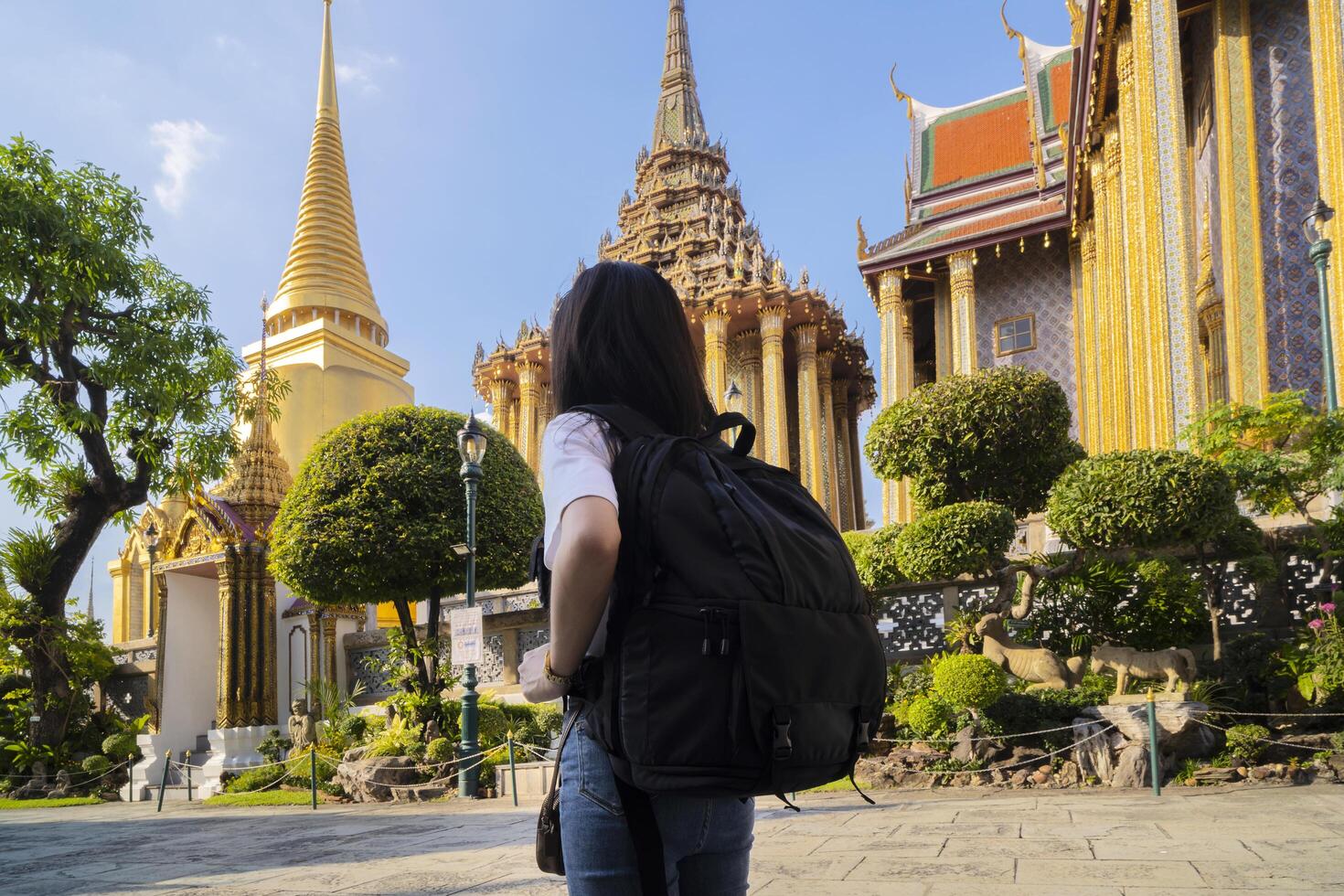 Asian tourist women travel in old Thai buddhist temple outdoor, in Wat phra kaew and grand palace travel in Bangkok city photo