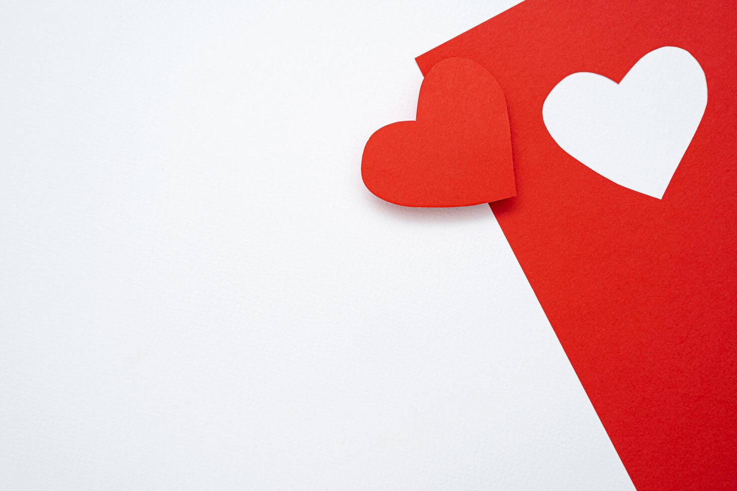 A red card cut into a heart shape, communicating on Valentine's Day. photo