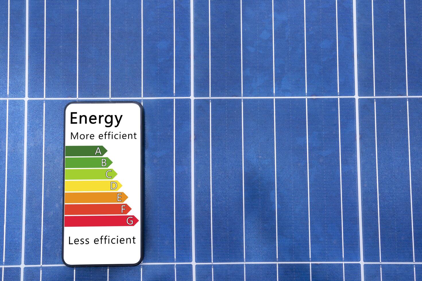 Solar panel, photovoltaic, alternative electricity source - concept of sustainable resources. Detail of house efficiency rating on digital smartphone screen saver. photo
