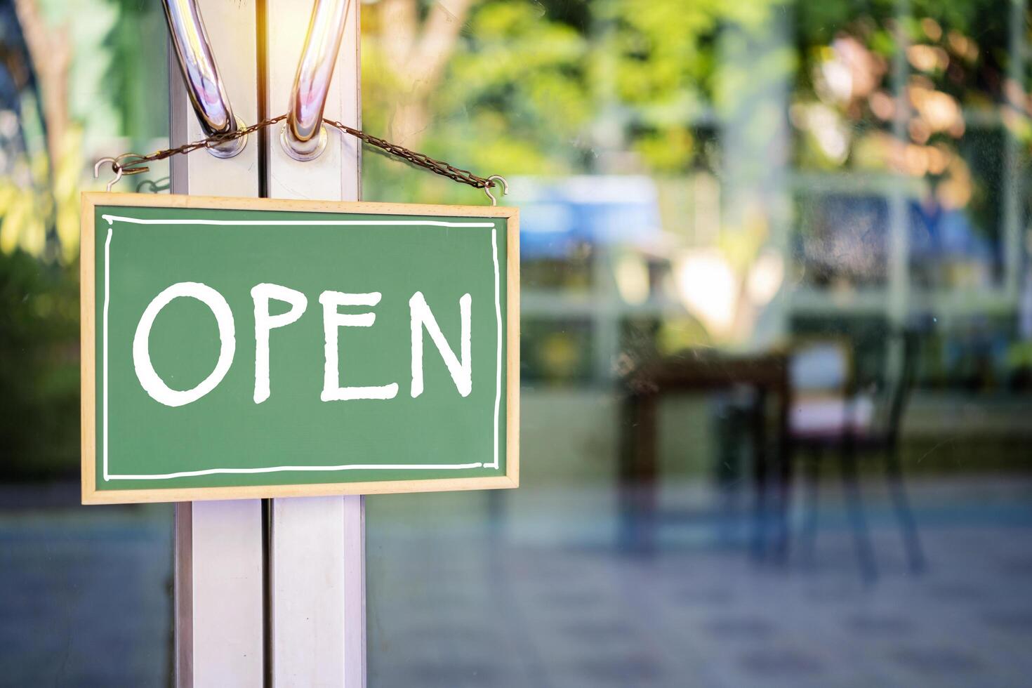 Close-up blackboard sign hanging at the shop door is labeled OPEN photo