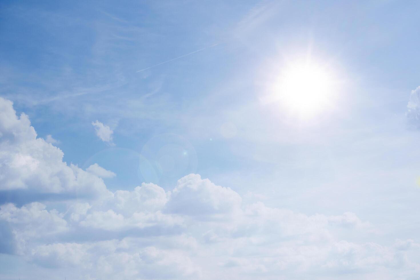 blue sky background with white clouds concept. The sun shines in a starry sky photo
