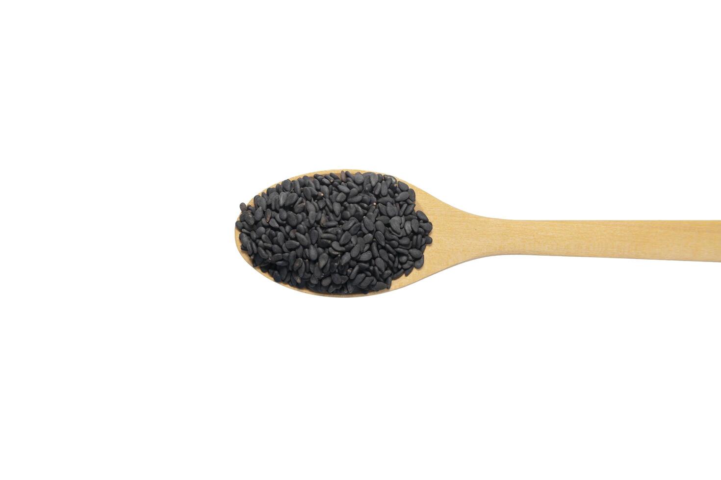 black sesame in wood spoon isolated on white background. full depth of field photo