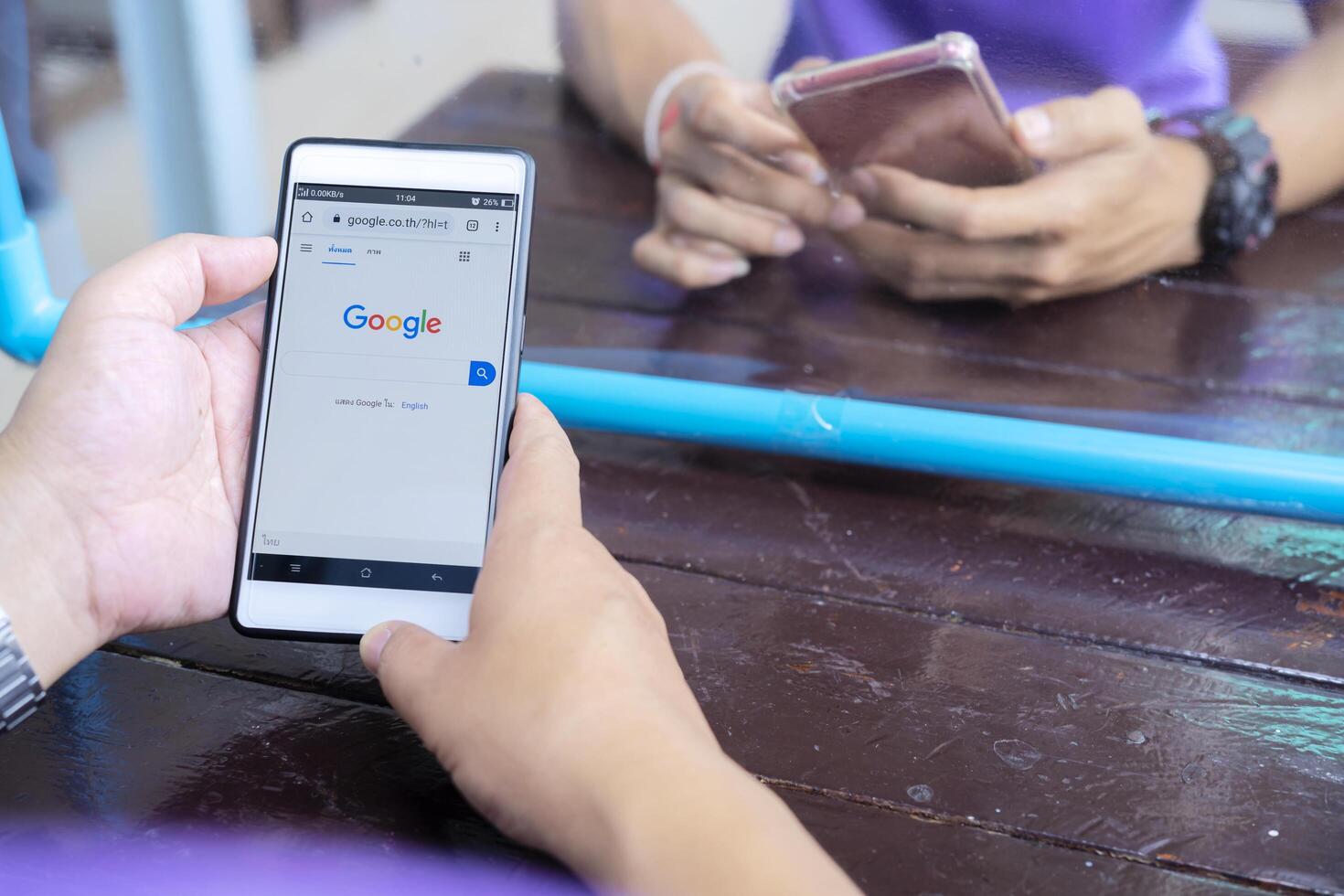 June 12, 2020 Bangkok, Thailand Asian men is typing on Google search engine from a smartphone. Google is the biggest Internet search engine in the world. photo