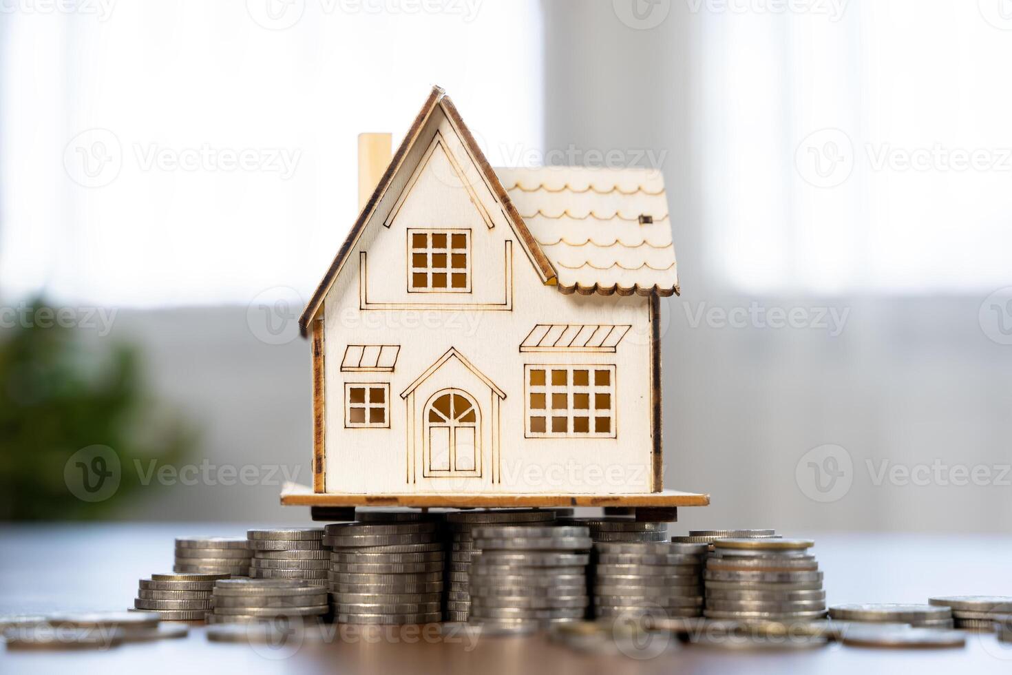 Mini house on stack of coins. Concept of Investment property. Concept for property ladder. photo