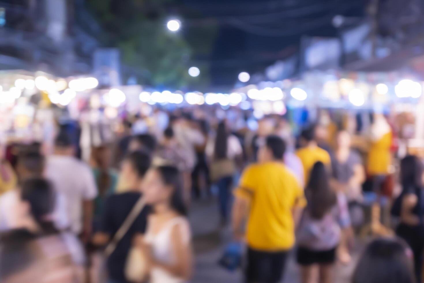out of focus picture of a crowd of people walking in the city photo