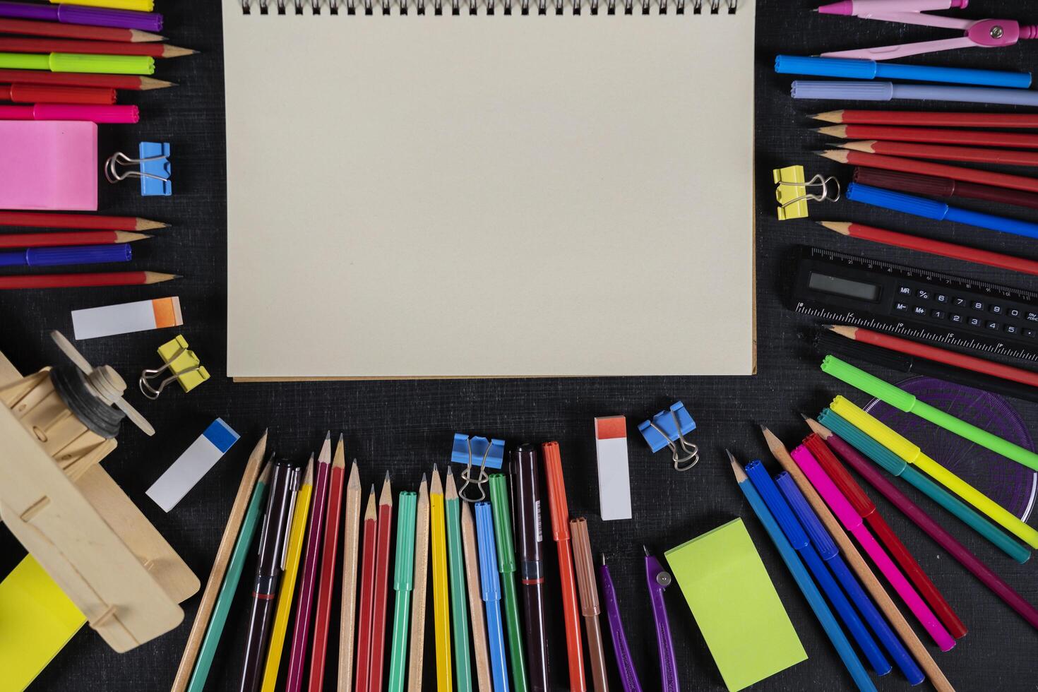 Top view on school educational supplies. Desktop with digital tablet, ruler, pencils, pens, notebooks, magnifying glass and cup of coffee. Studying and researching background, copy space photo