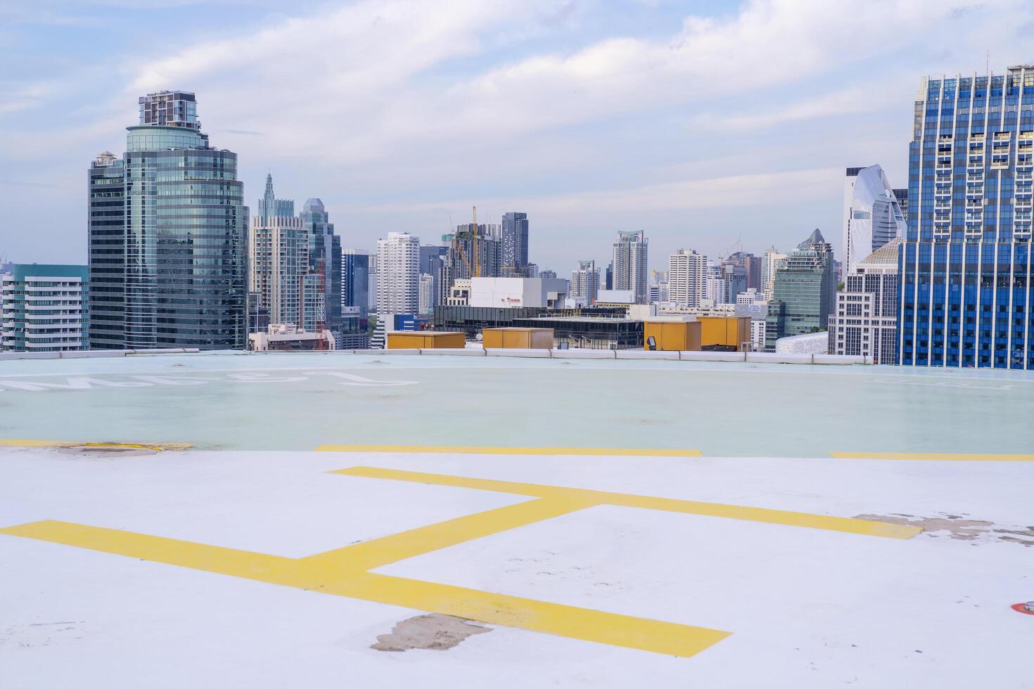 Helipad on the roof of a skyscraper with cityscape view photo