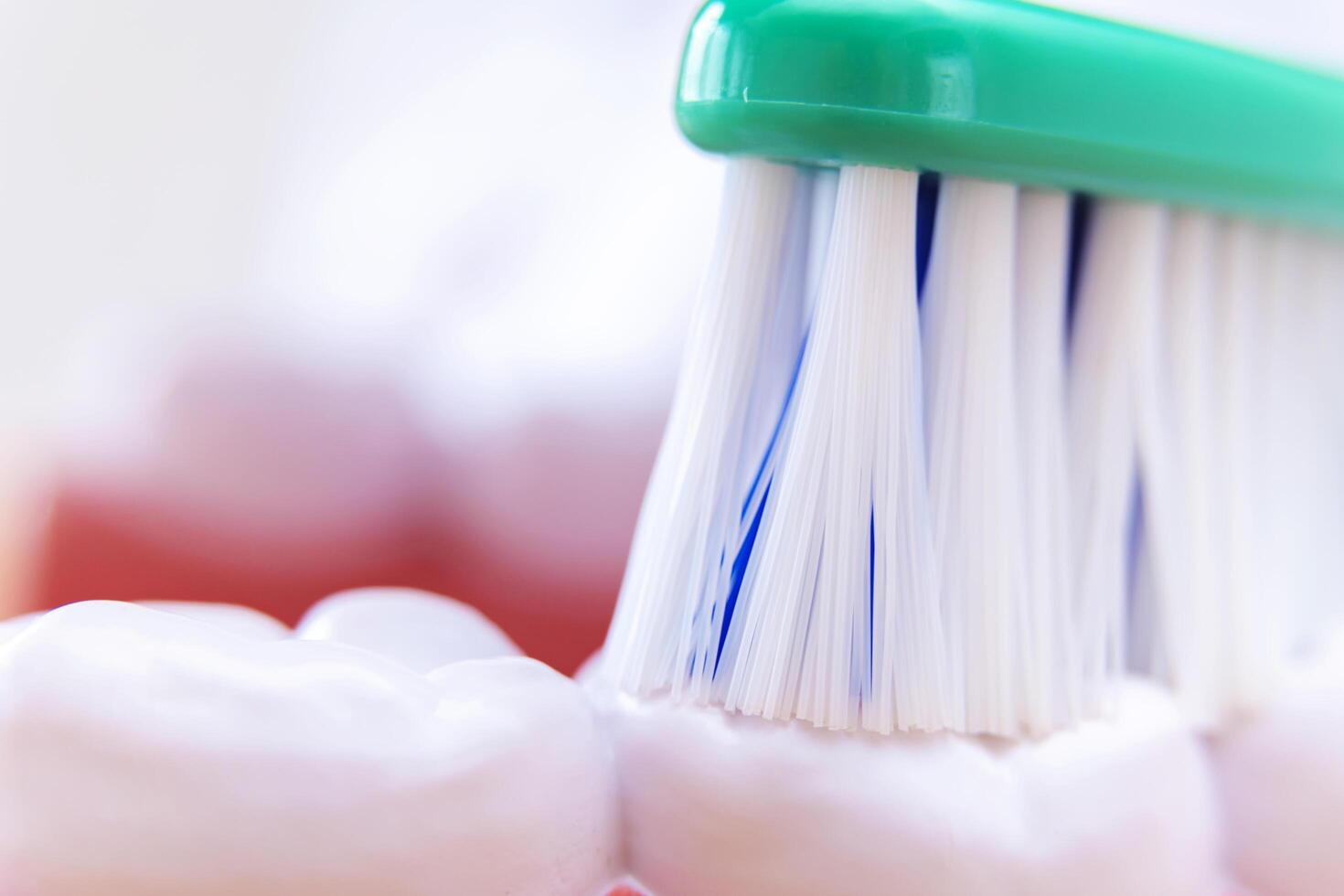 Macro photo of toothbrush that is rubbing teeth
