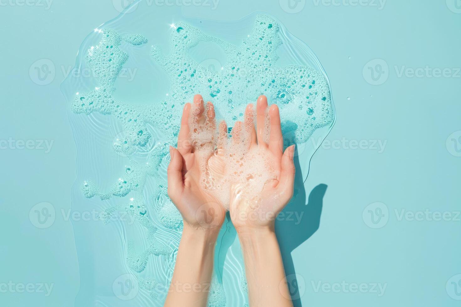 Hands with soap suds on aqua background photo