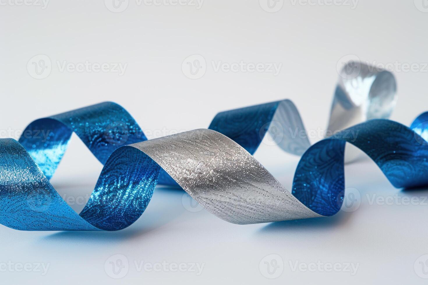 Blue and silver curled ribbon on white background photo