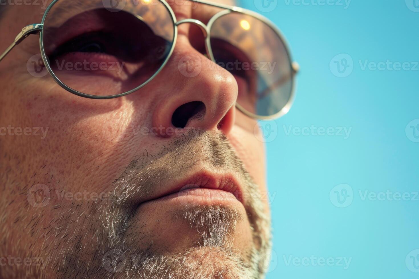 Closeup portrait of a bearded man with sunglasses photo