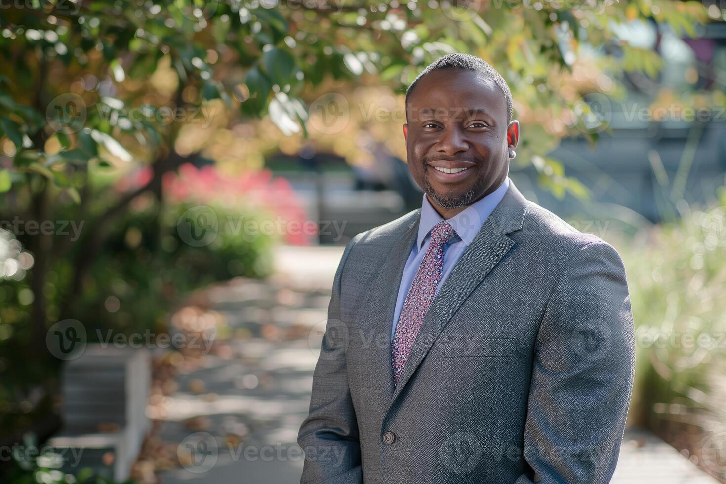 Confident african american businessman smiling in an outdoor garden setting photo