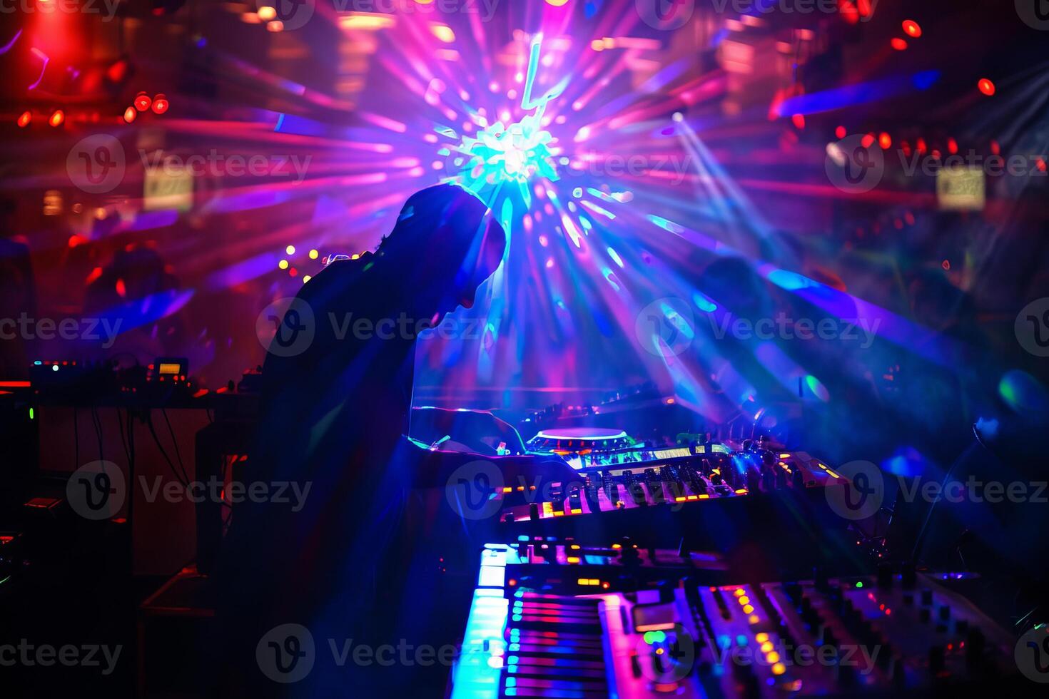 Dj performing at nightclub with vibrant lights photo