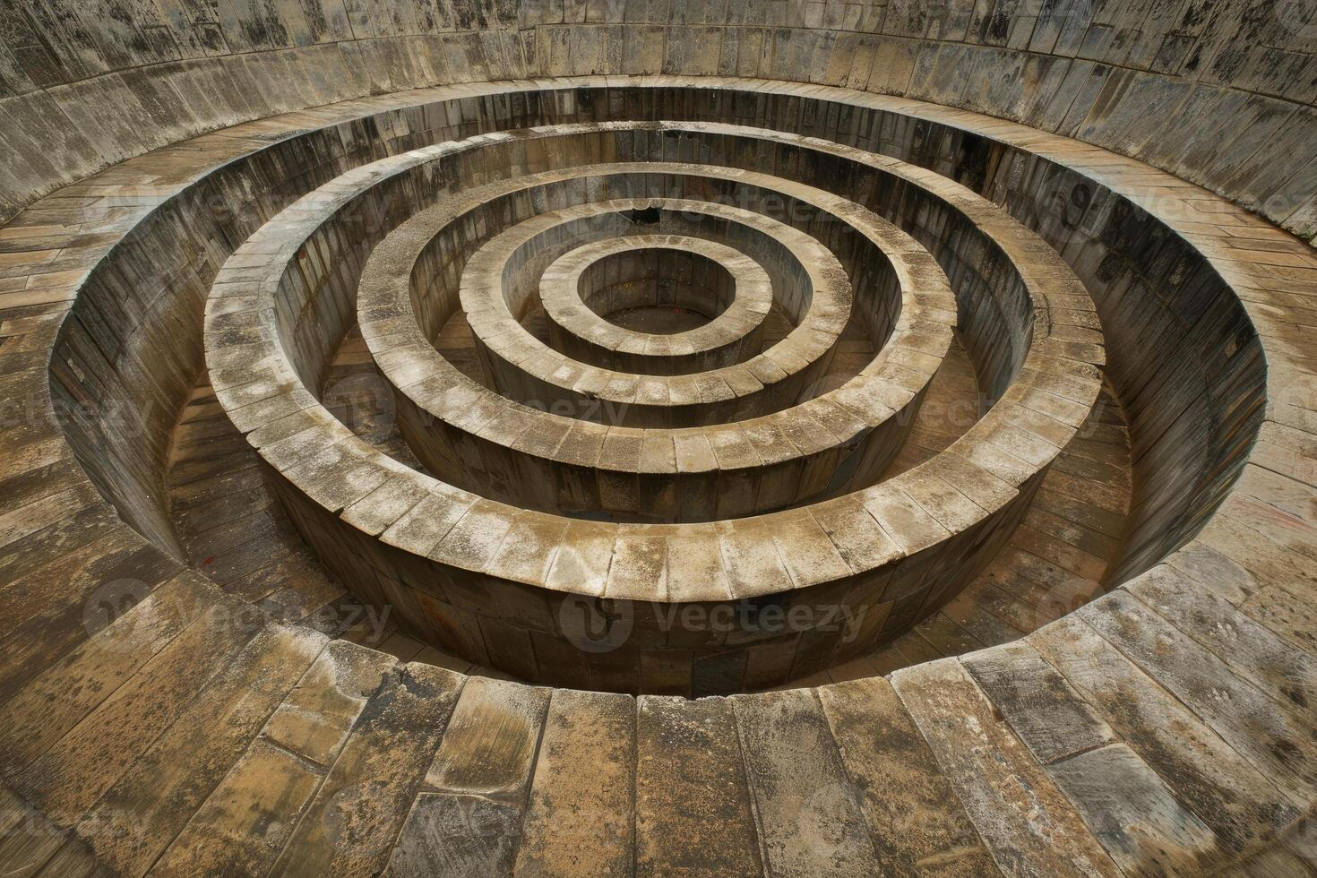 Majestic ancient circular stepwell, with symmetrical step pattern, historical site photo