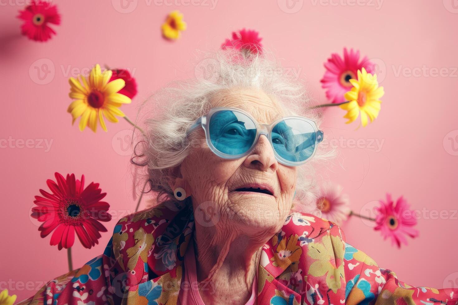 Joyful senior lady with funny sunglasses and flowers photo