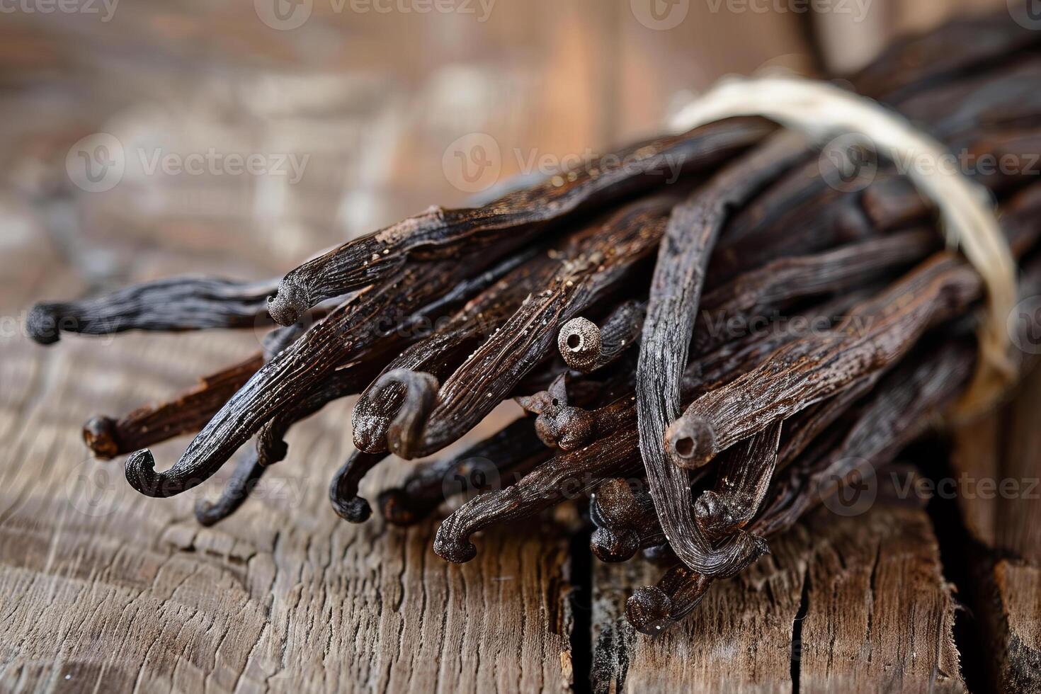 Bundle of vanilla pods on rustic wooden surface photo