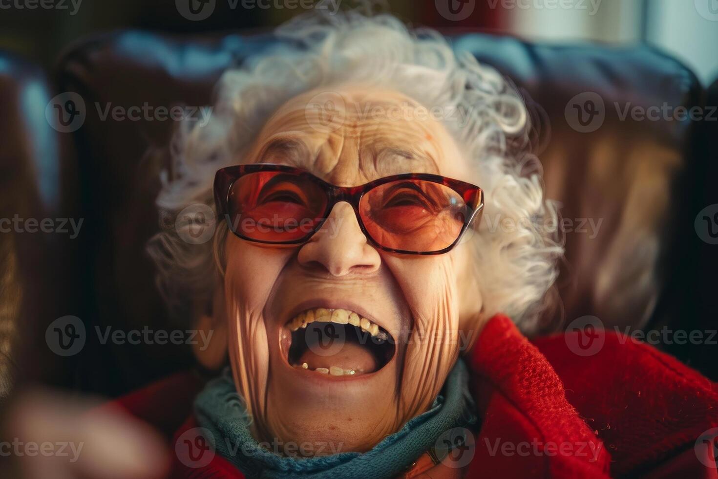 Joyful senior lady laughing with red glasses photo