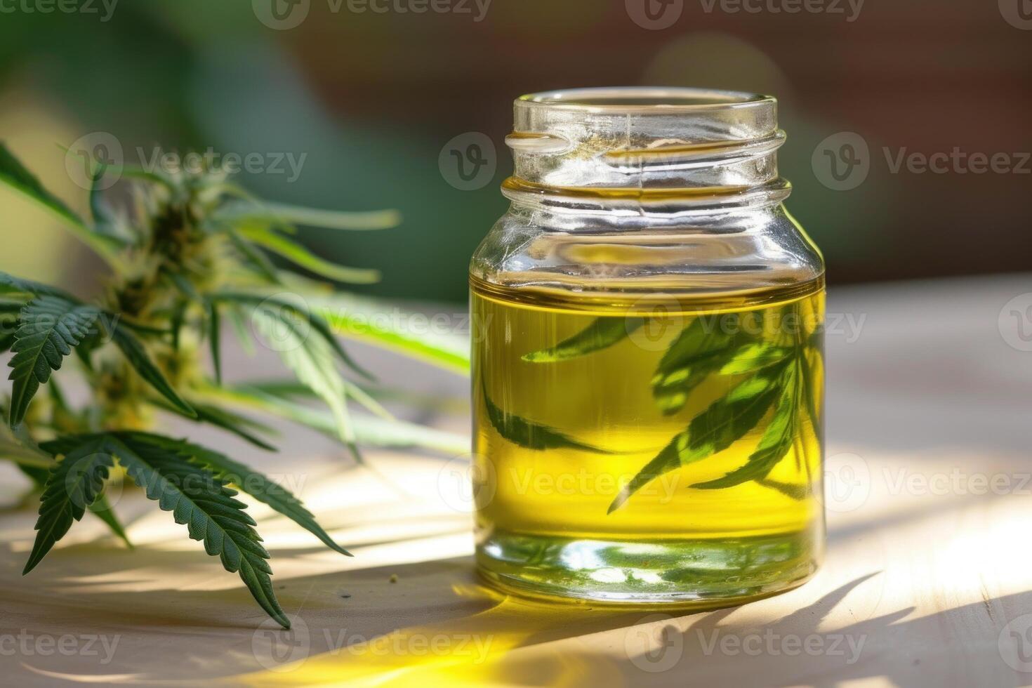 Cbd oil bottle with hemp leaves on wooden surface photo