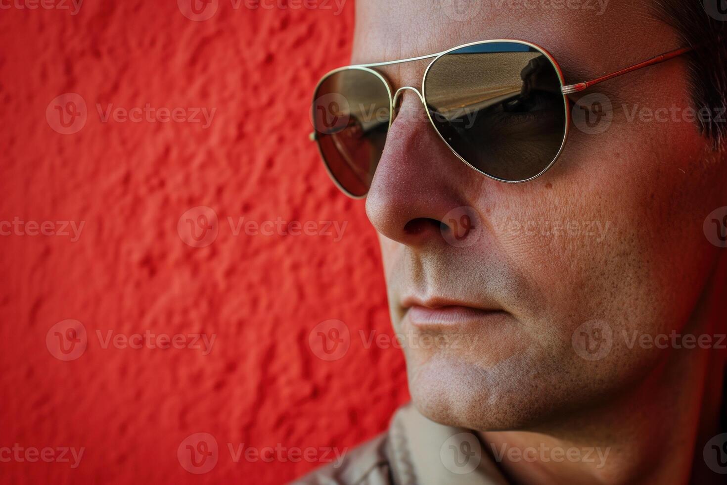 Cool man with sunglasses against red wall photo