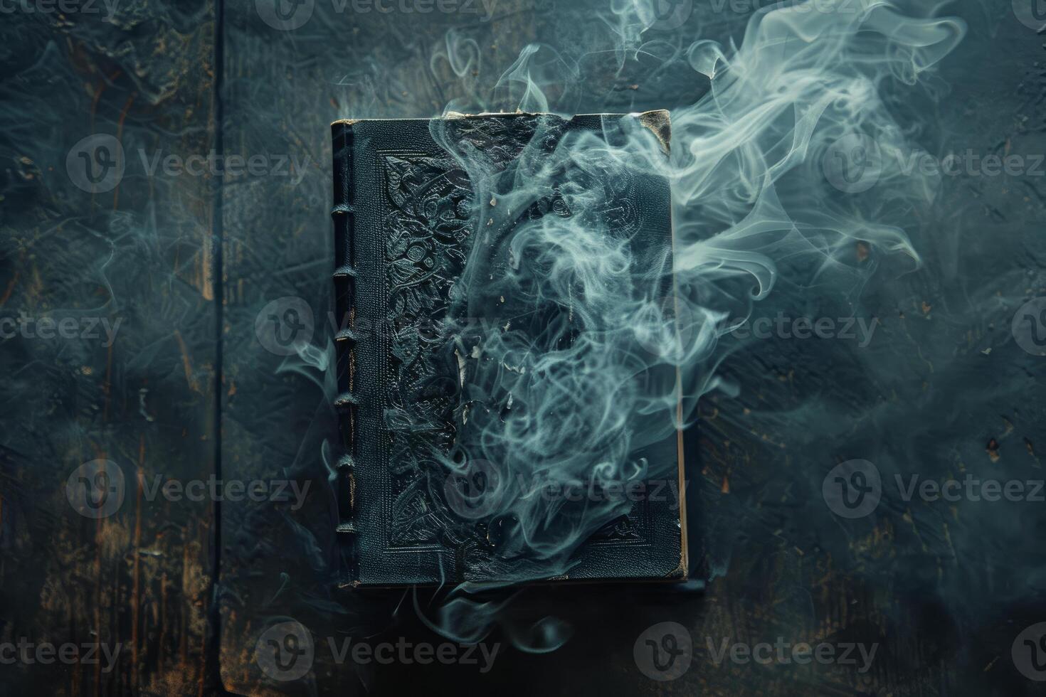 Ancient book with smoke emanating from its pages on a dark wooden table photo