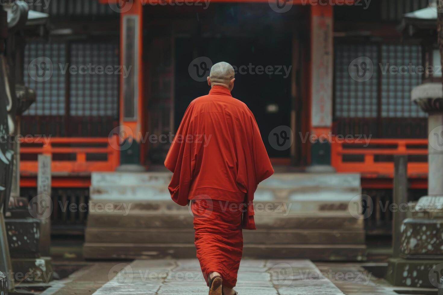 Buddhist monk wearing red robe walking at japanese temple photo