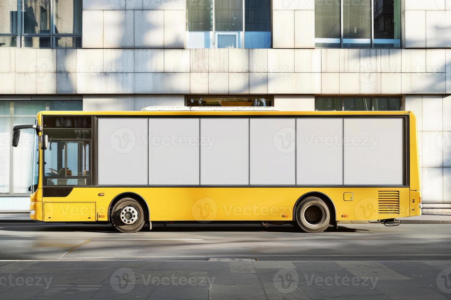 Yellow bus with blank mockup on side standing near modern building photo