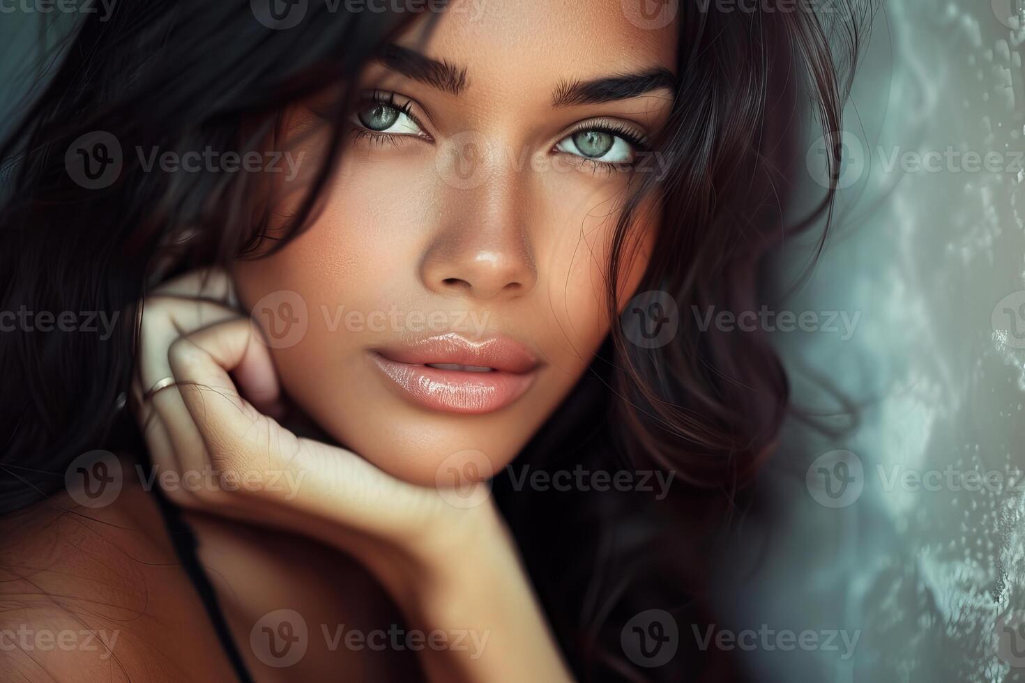 Beautiful latin woman with long dark hair and green eyes posing in sunlight photo