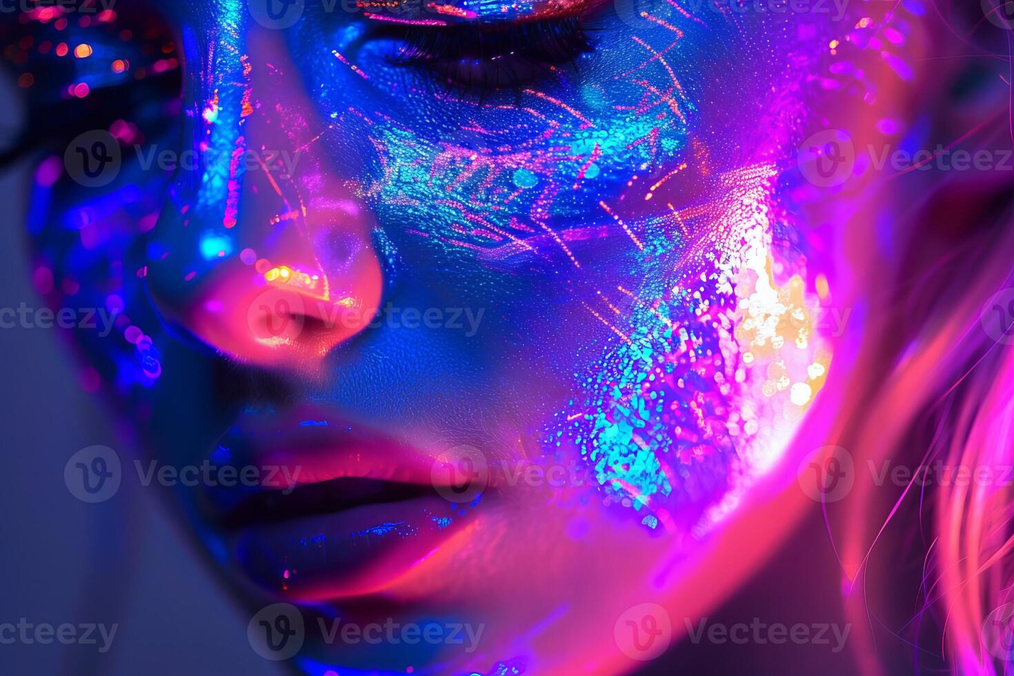 Beautiful model posing with creative glowing make up under uv light photo