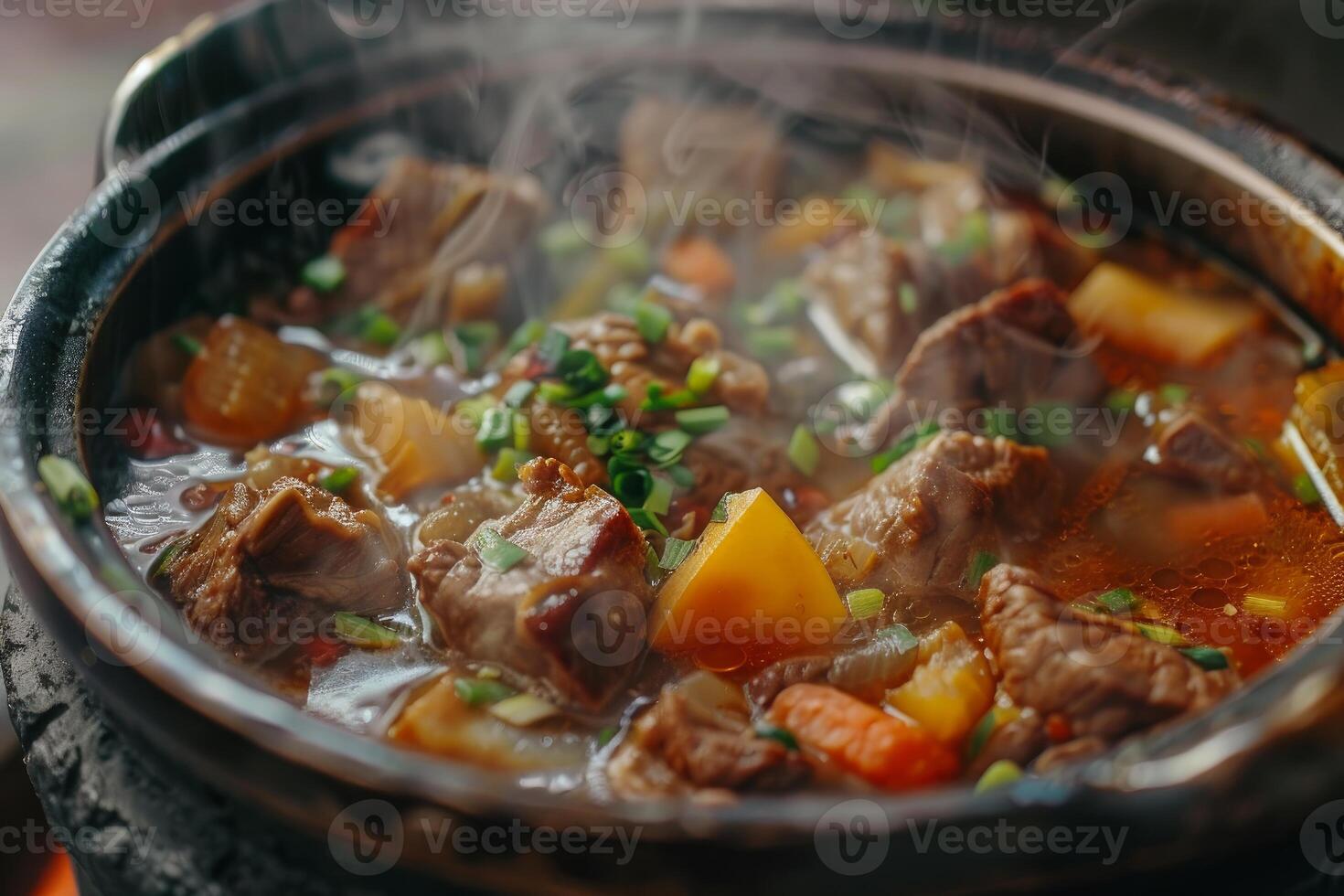 Delicious beef stew simmering in a cast iron pot on a stovetop photo