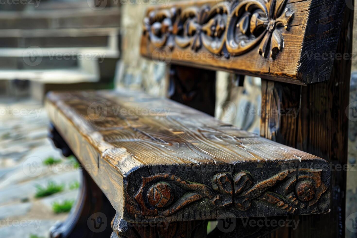 Old ornamented wooden bench standing in front of stone steps photo