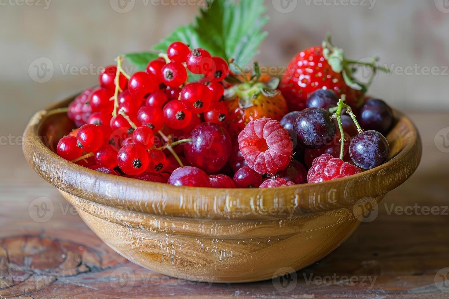 Wooden bowl overflowing with freshly picked red currants, raspberries, and blueberries photo