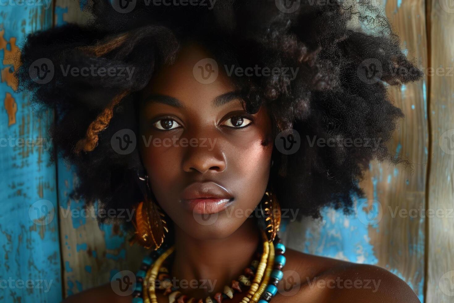 Portrait of a beautiful young black woman with afro hairstyle and ethnic jewelry photo