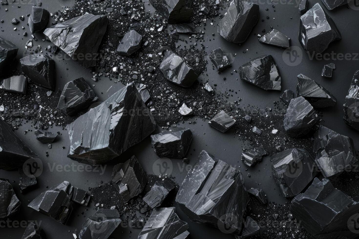 Black tourmaline scattered on dark background creating abstract pattern photo