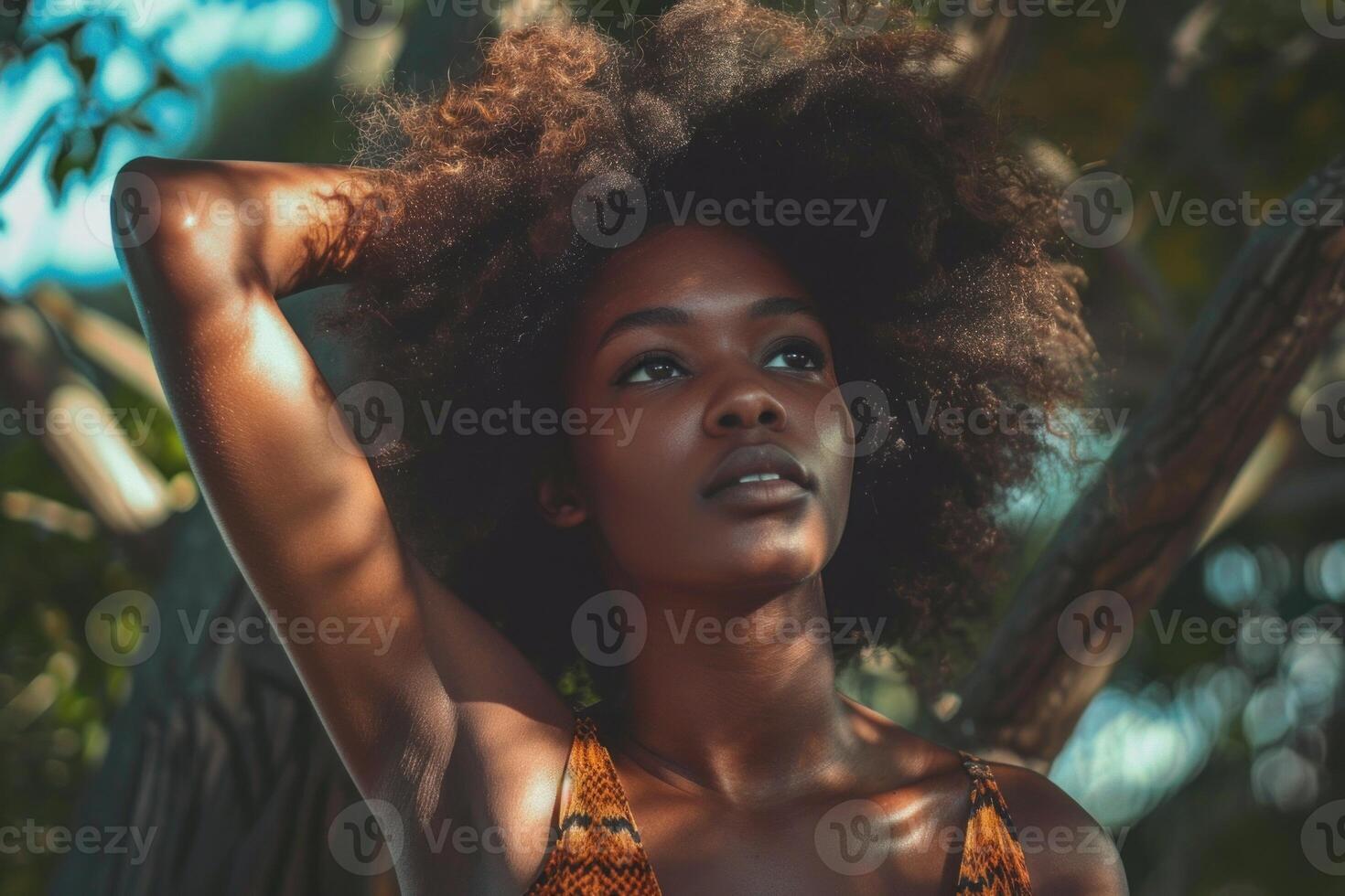 Beautiful black woman with afro hair posing in nature photo