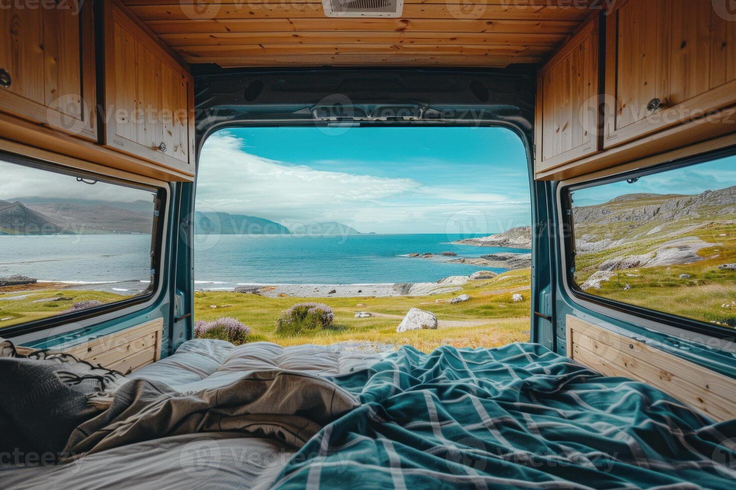 Camper van facing beautiful ocean scenery with open back doors photo