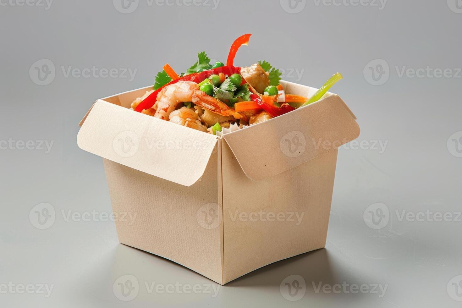 Wok food with shrimps and vegetables in take away box photo