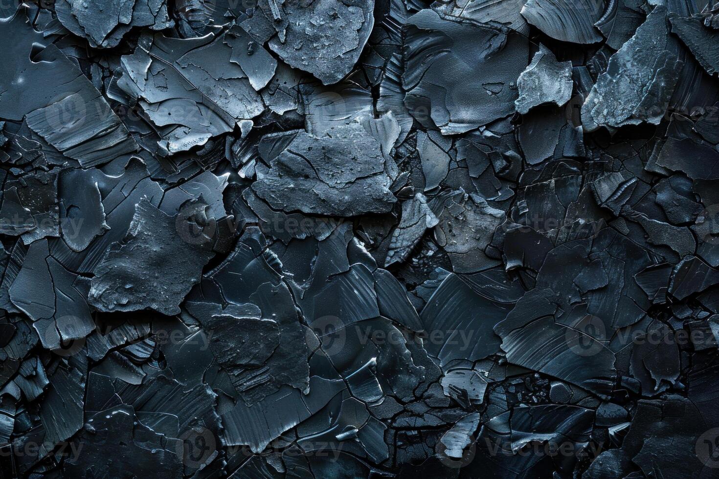 Abstract black painted stone texture background forming an irregular pattern photo